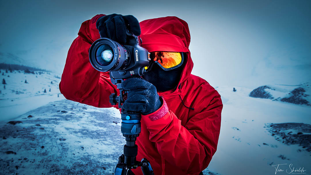 A photographer taking a photo in a frigid ice field