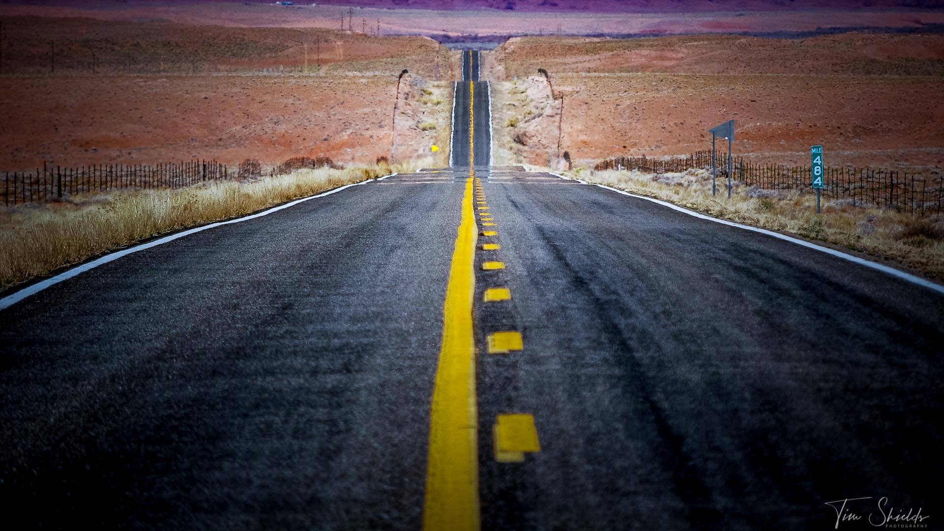 A photo of a long, straight road in Death Valley