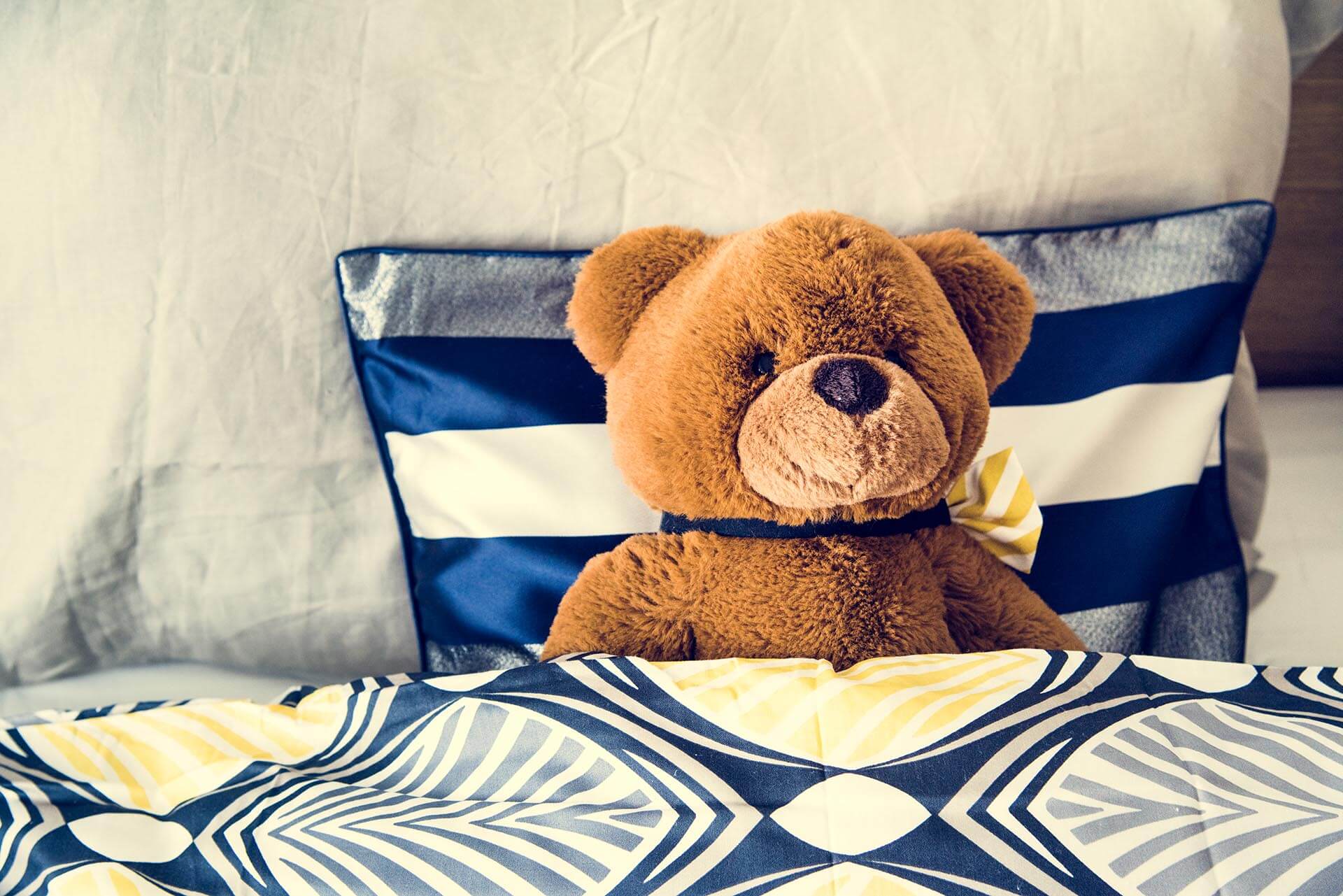 A photo of a Teddy bear on the bed